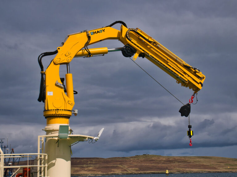 Hydraulic marine crane installed on a vessel deck for safe lifting operations